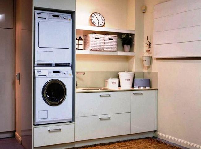 Compact laundry design with machines in cupboards and lots of draw and storage space