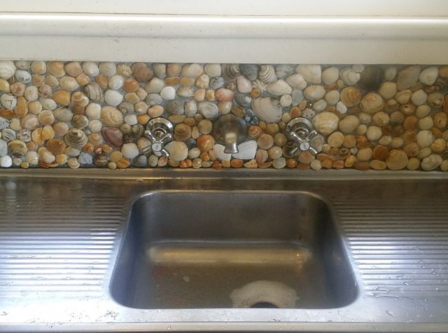 Kitchen splashback area renovated using real shells glued over existing laminate.